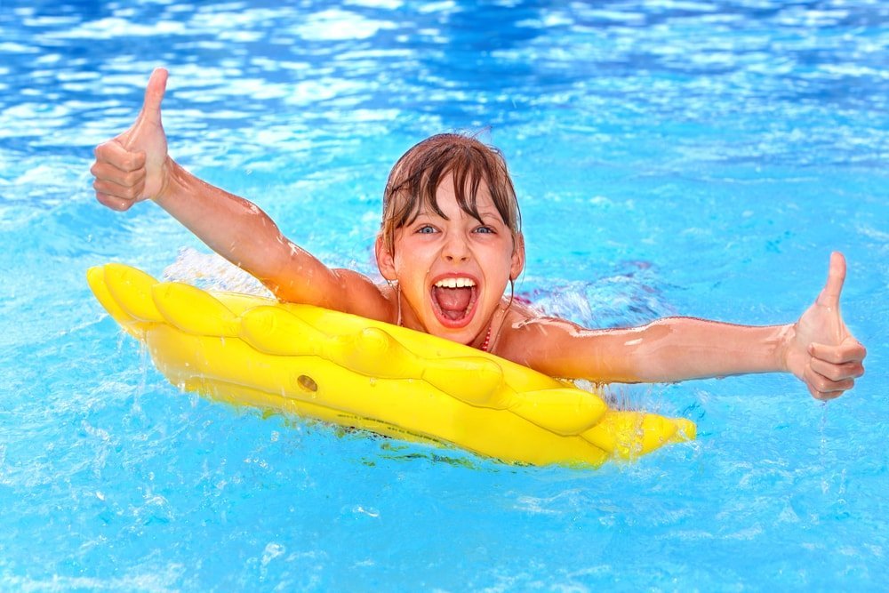 boy swimming and giving thumbs up
