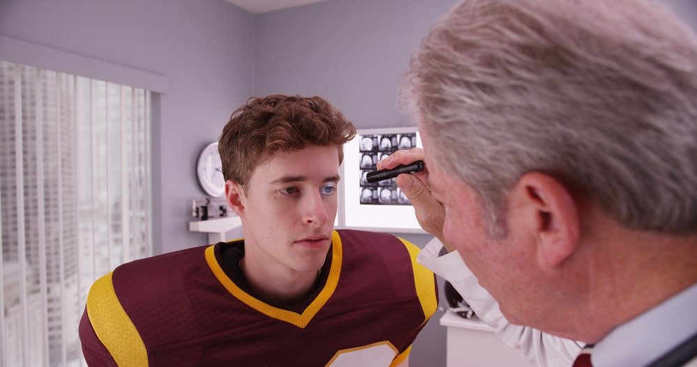 Teen Football Player Getting Concussion Treatment