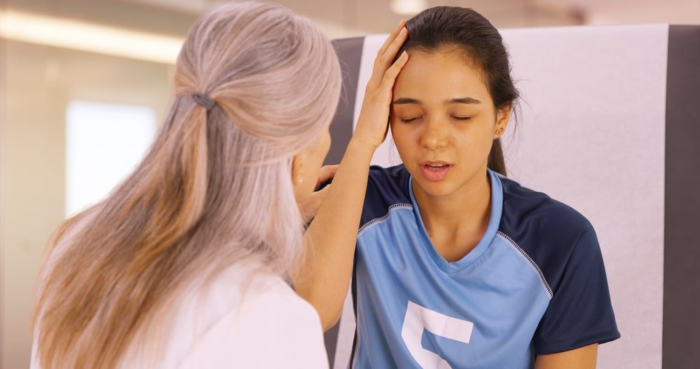 Teen Girl With Headache Getting Concussion Treatment