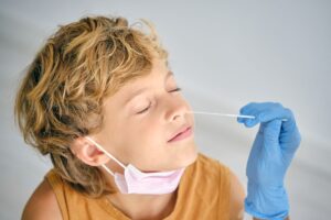Crop Nurse Taking Covid Test From Boy in Clinic 1