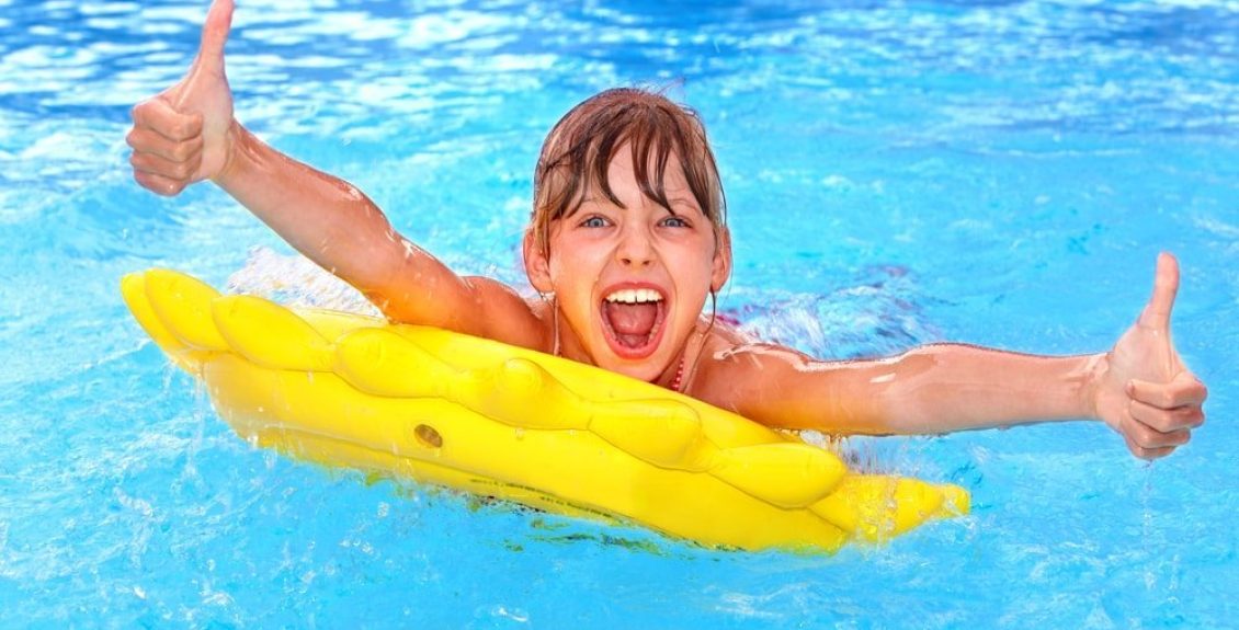 boy swimming and giving thumbs up