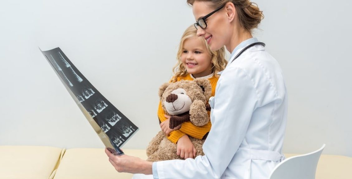 Doctor Showing X-Ray To Young Girl