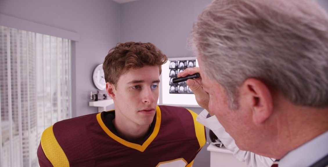 Teen Football Player Getting Concussion Treatment