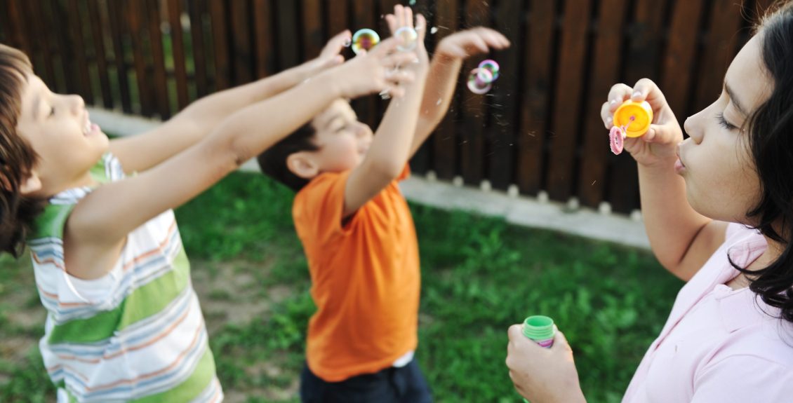 Children playing with bubbles outdoor