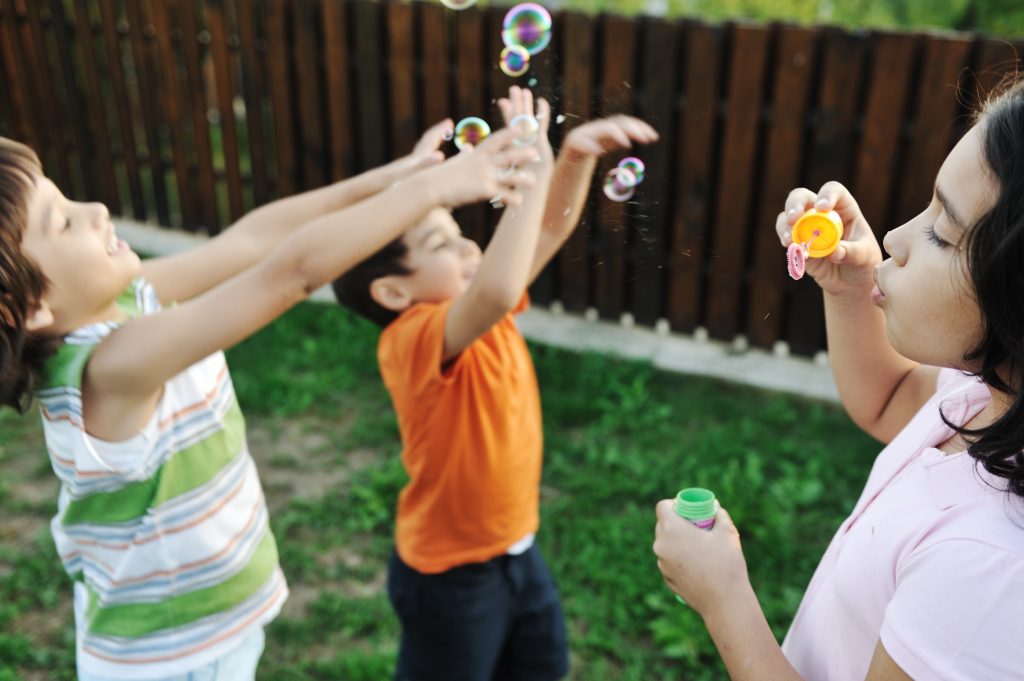 Kids playing with bubbles together